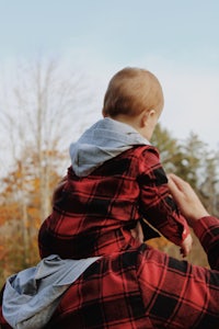 a man holding a baby in his arms