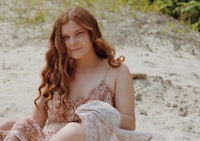 a woman sitting in the sand