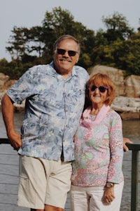 a man and a woman standing next to a body of water