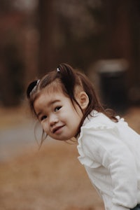 a little girl is holding a skateboard