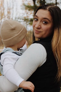 a woman holding a baby in her arms