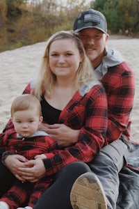 a family sitting on a blanket on the beach