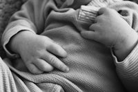 a black and white photo of a baby with a pacifier