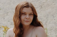 a young woman with red hair is posing for a photo