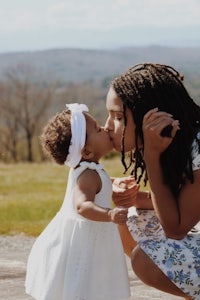 a woman kissing her daughter