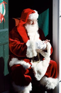 a santa claus sitting in a doorway