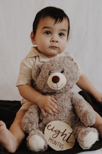 a baby holding a teddy bear