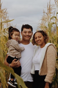 a family posing for a photo in a corn field