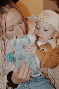 a woman holding a stuffed koala bear