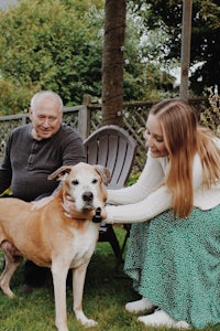 a woman petting a dog