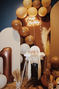 a baby's first birthday party with balloons and confetti