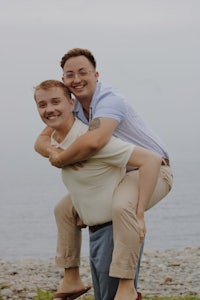 a man is carrying a man on his back