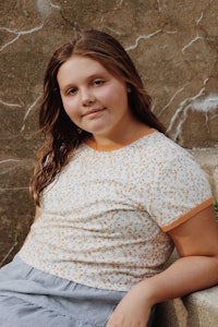 a young girl sitting on a set of steps