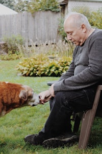 a man is petting a dog