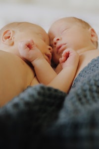 twins sleeping on a bed